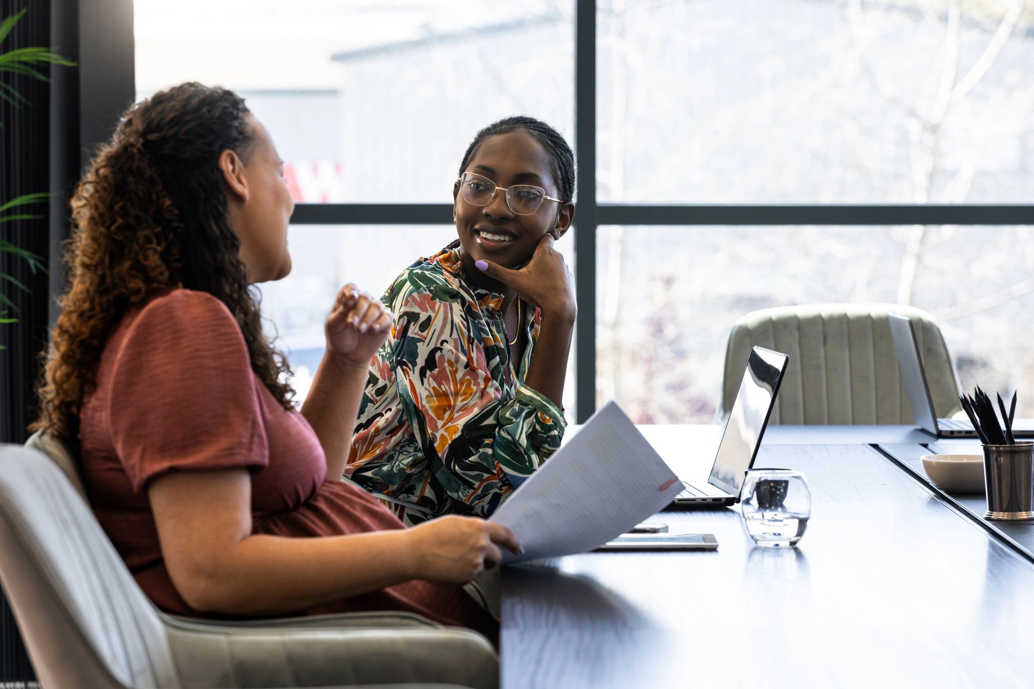 Two professionals discussing financial education at a table