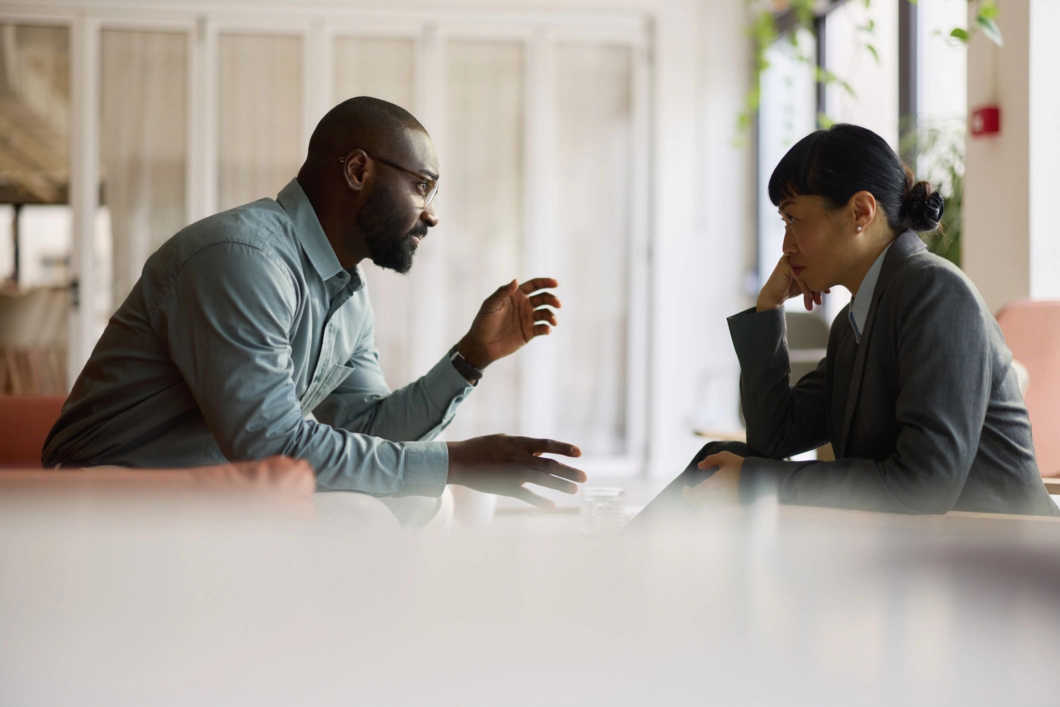 Two professionals discussing financial education in an office