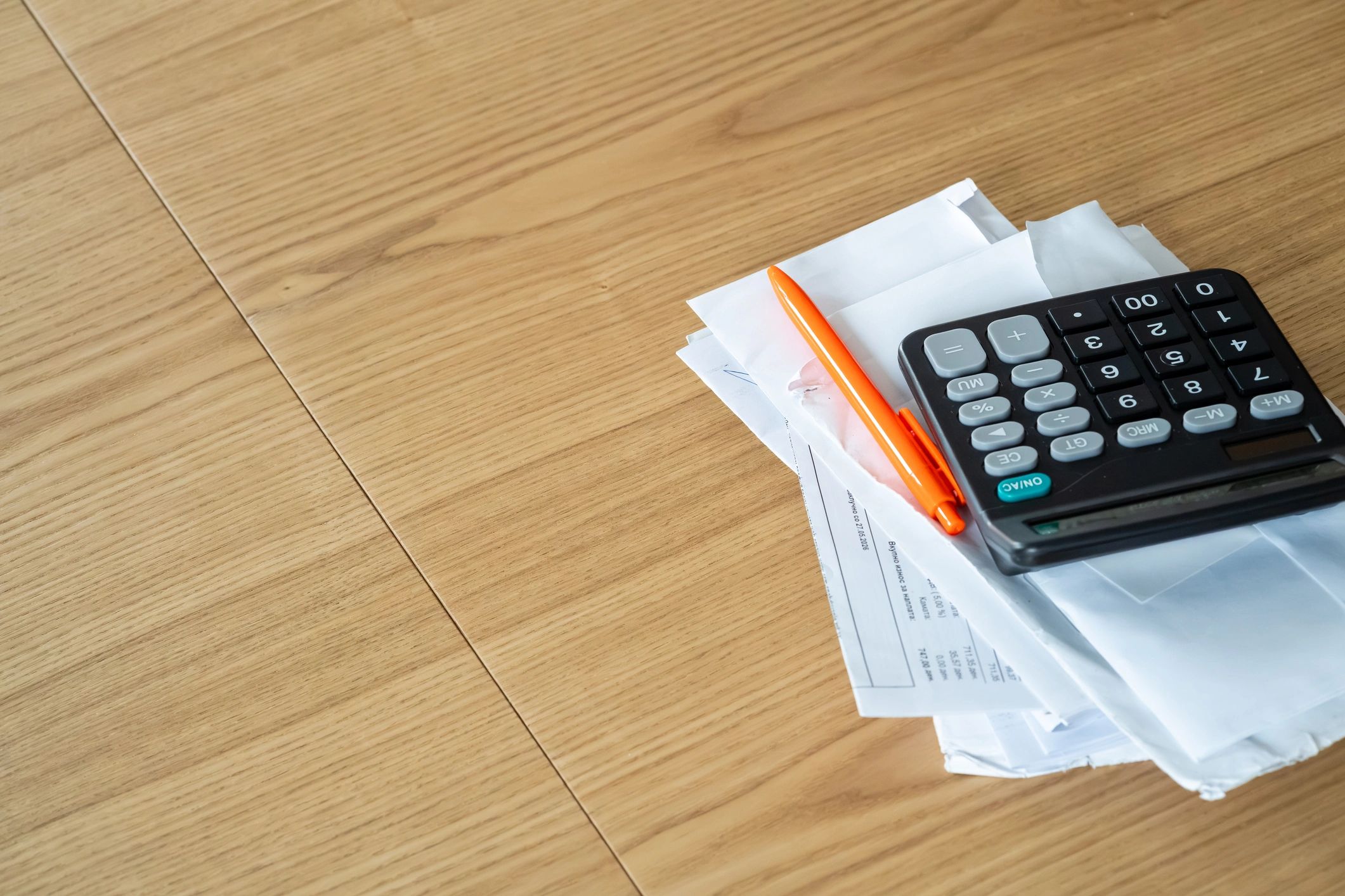 Calculator and financial documents on a desk